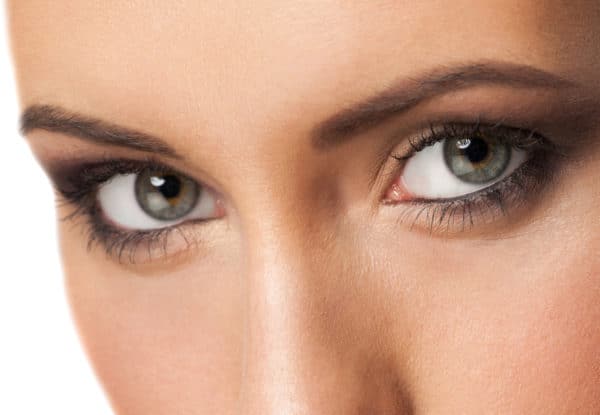 Close-up shot of beautiful female eyes with bright fashion makeup